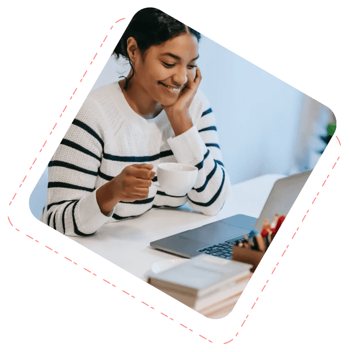 contract worker staring at her laptop and sipping tea