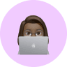 a memoji of a girl working on a laptop
